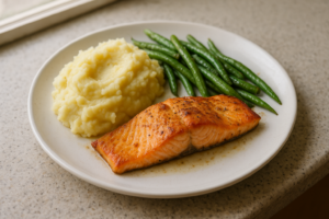 Bord met zalm, romige aardappelpuree en boontjes