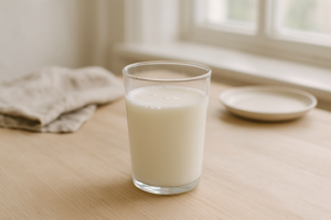 Glas karnemelk op een lichte keukentafel bij daglicht